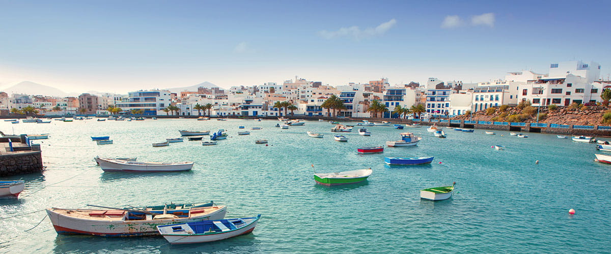 Whitewashed cottages around the coastal lagoon of El Charco de San Gines.